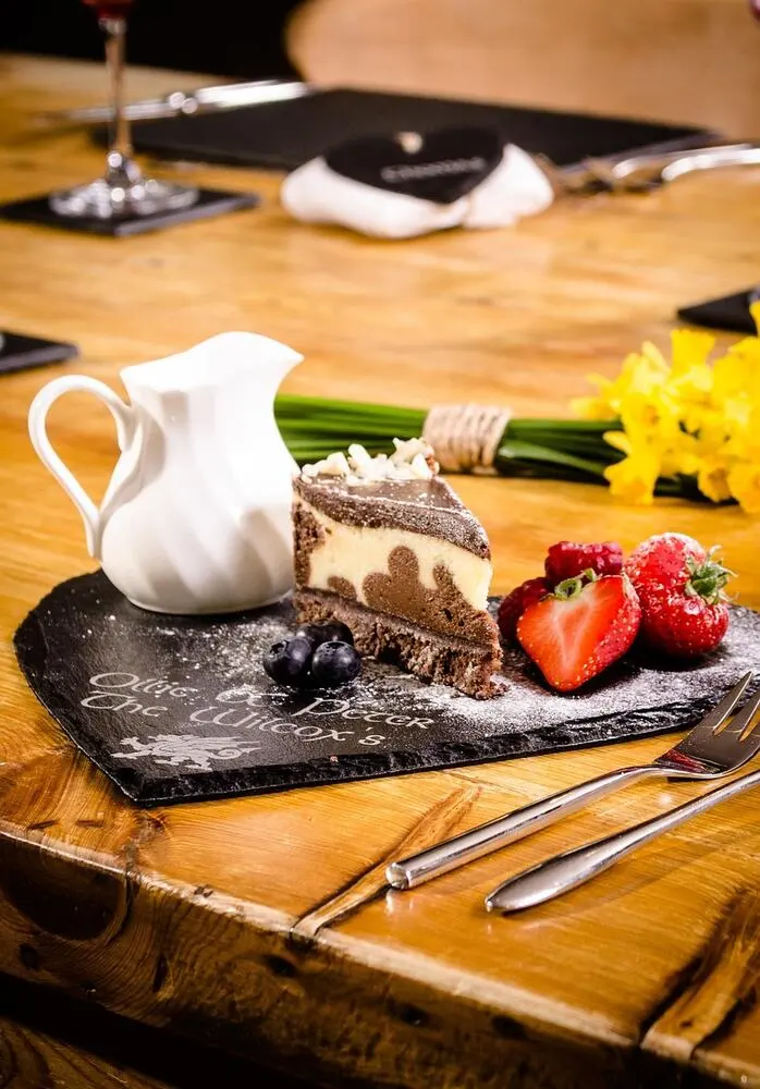 Chef plating a dish at a fine dining restaurant in the United Kingdom