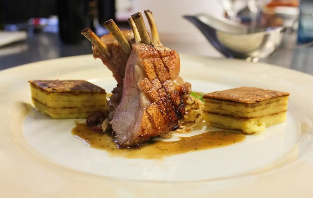 Gourmet suckling pig main course typical of a modern tasting menu