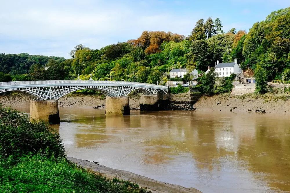 Rural Welsh village with river and stone bridge